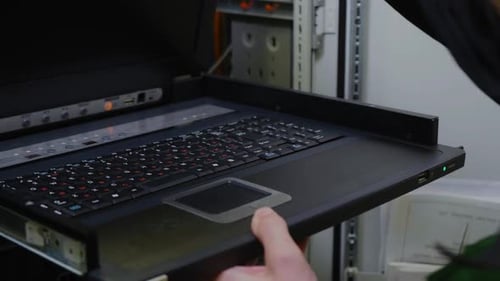 Technician Takes Laptop and Checks System in Server Room