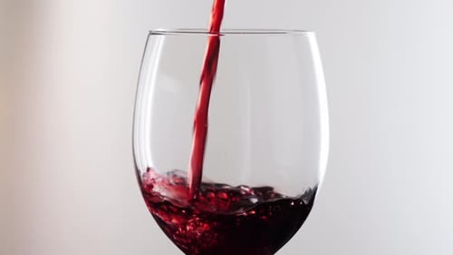 Red Wine Being Poured into Clear Glass
