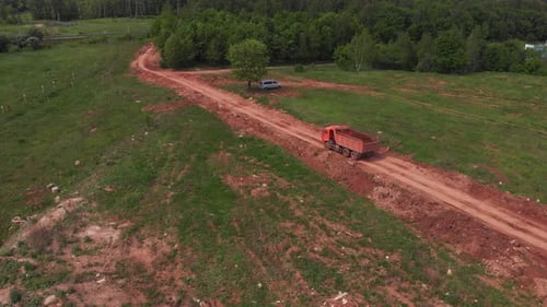 Tipper Truck Carries Dirt Driving Along Road Aerial View