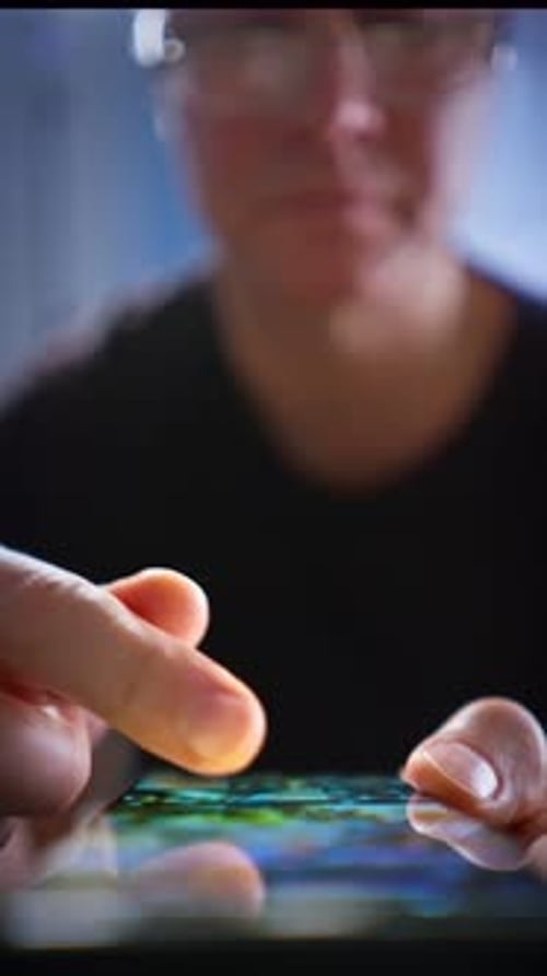 A Closeup of Male Hands Interacting with a Smartphone