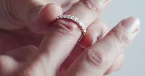 Close up of a girl's hand trying a diamond ring. Concept: jewelry, fashion, style