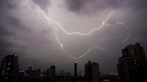 Lightning and rain in modern city center of Bangkok.