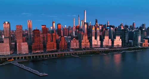 Last rays of setting sun on the tops of skyscrapers in the downtown of New York, the USA.