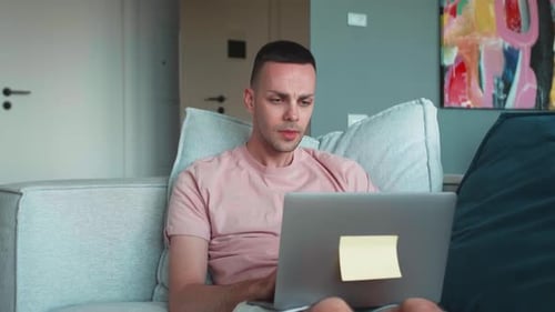 Young Adult Working on Laptop at Home