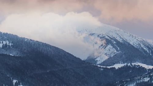 Clouds Moving Over the Mountain During Twiligh in Winter Landscape