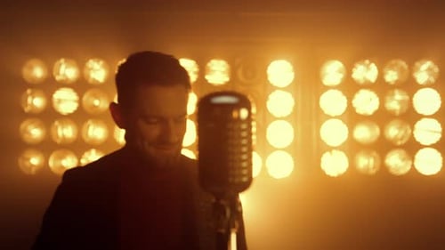 Cheerful guitarist enjoys performing rock solo on stage night club lights