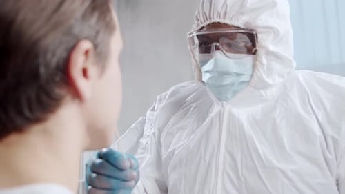 AfricanAmerican Doctor Makes a Coronavirus Test Medical Worker and Patient at the Hospital Office