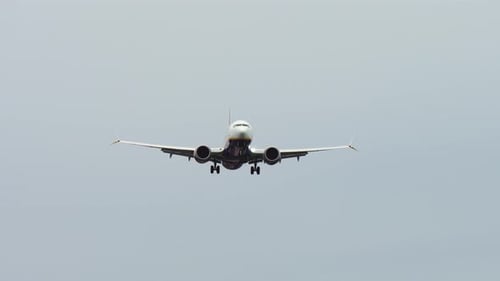 Passenger Plane Gently Descending for Landing Aircraft Smoothly Approaching Runway During Overcast