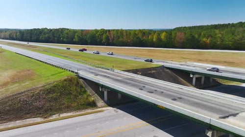 Aerial View of Freeway Overpass Junction with Fast Moving Traffic Cars and Trucks in American Rural
