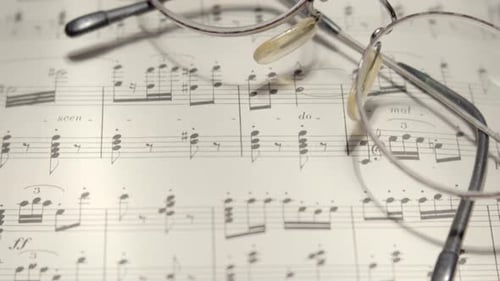 View over musical notes and glasses