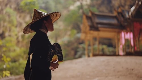 Woman Looking At Landscaping And Walking Near Pavilion