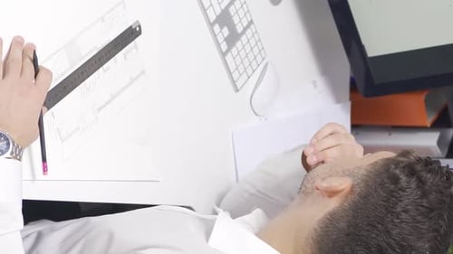 Vertical Video of Male designer working in modern office for a new project.