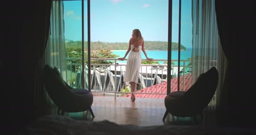 Woman Enjoys Tropical Ocean View from Balcony