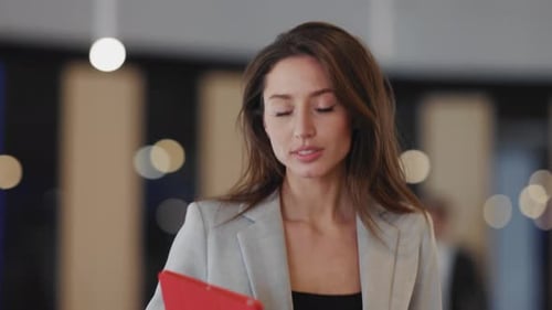 Business Woman Walking with Tablet in Modern Office