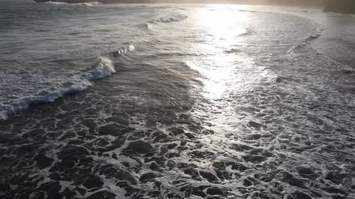 Aerial view of beautiful sunset at Beach in Indonesia with yellow sunny day.