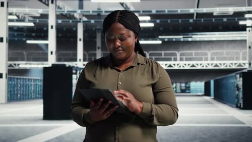 Programmer Runs Equipment Checkups with Tablet Device in Data Center