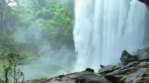 View of a waterfall from inside a cave in Tropical paradise