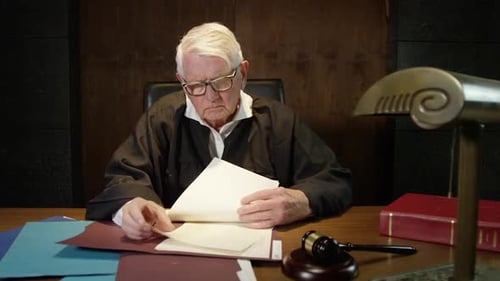 Judge going over all his papers in court legal scene