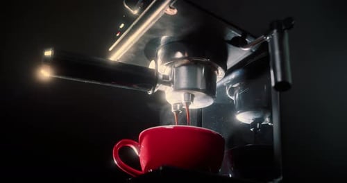 Espresso Machine Brewing Coffee into a Red Mug