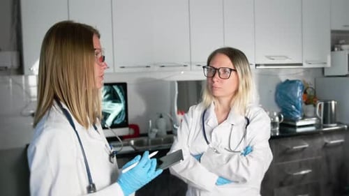 Doctor and nurse discussing patient results in hospital office. Partnership in medicine concept.
