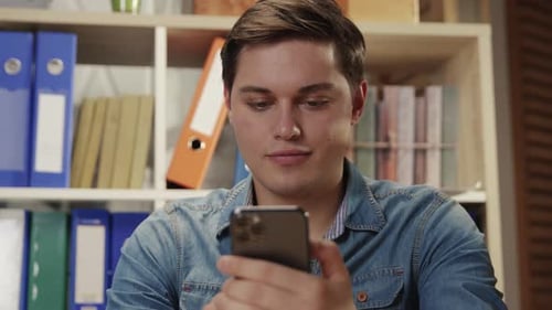 Young Adult Using Smartphone Indoors