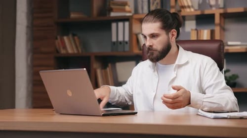 Excited Young Adult Working at a Desk