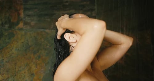 Relaxing Woman Cleansing in Stone Shower
