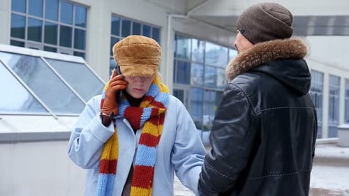 Woman Talking on Phone Holding Hands With Man