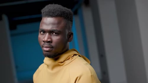 Close Up of Man in Gold Hoodie Looking