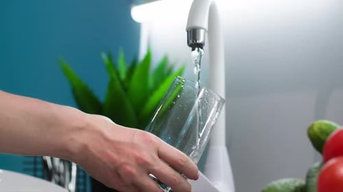 Filling Glass with Water from White Faucet