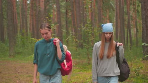 Young Hikers Walking Through Forest
