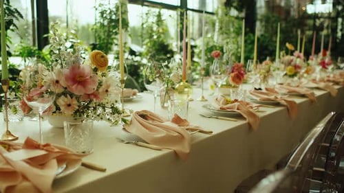 Elegant Wedding Table Setting with Flowers and Candles
