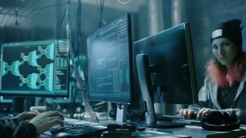 Hackers Coding at Computers in Dark Room at Night