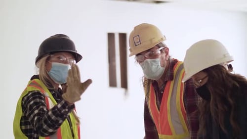 Construction team having a planning meeting indoors in Canada