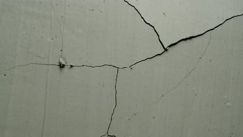 Impact Collection: Effect of a grey concrete wall cracking from center