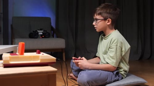 Boy Playing Retro Video Game at Home