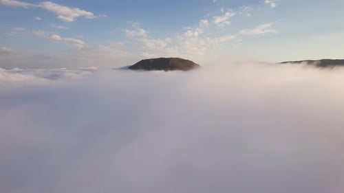 Aerial View of Mountains Over a Sea of Clouds