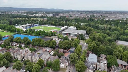 Aerial View Of Modern Sports Stadium Surrounded By Lush Greenery