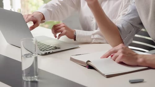 Professionals Collaborating at Desk in Modern Office