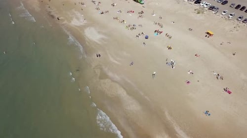 Mediterranean beach during summer with people in the water