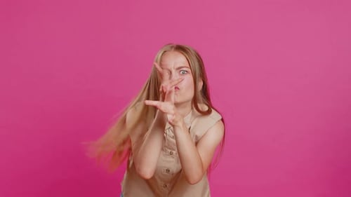 Young Woman Making Silly Faces on Pink Background