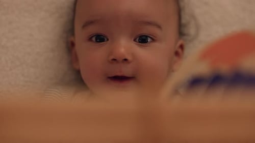 Sweet Infant Lying Down and Smiling Up