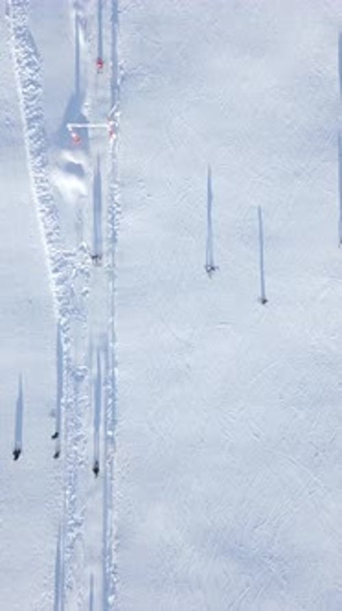 Top View of Ski Lift with Skiers and Snowboarders on Ski Slope at the Ski Resort
