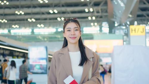 Portrait of Asian young girl walk in airport terminal to boarding gate.