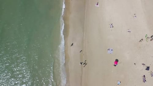 Mediterranean beach during summer with people in the water