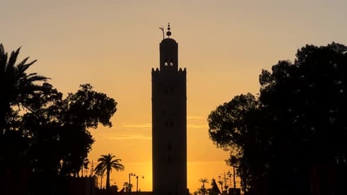 Kutubiyya or Koutoubia Mosque in Marrakech city silhouetted at sunset