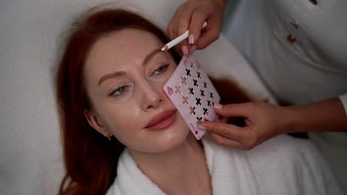 Top View of Beautician Applying Marks with Palette on Woman Face Preparing for Cosmetic Procedure in