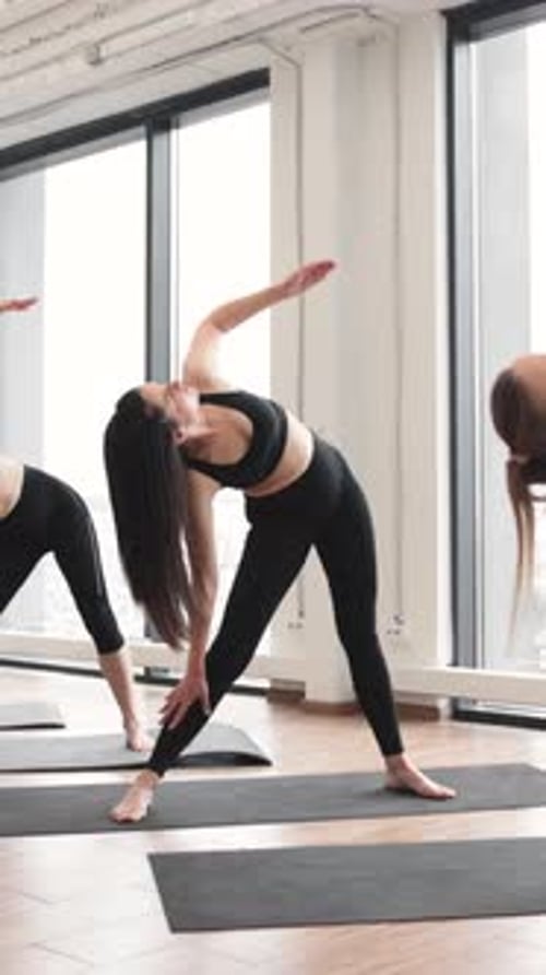 Women In Sportswear Doing Triangle Yoga Pose