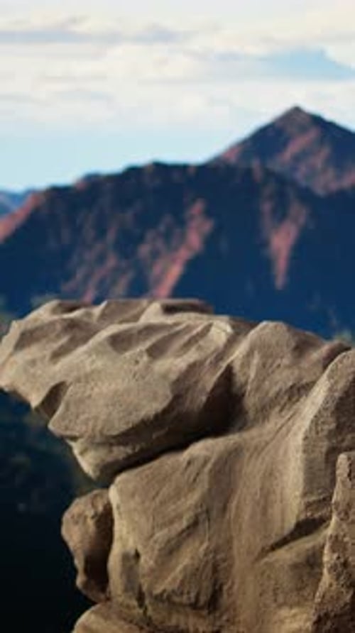 Vertical Video Rugged Rocky Ledge Overlooks a Breathtaking Mountain Range