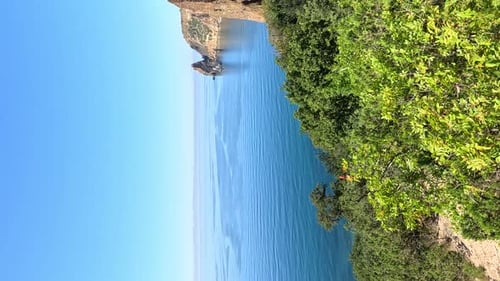 Aerial View on Calm Azure Sea and Volcanic Rocky Shores Small Waves on Water Surface in Motion Blur